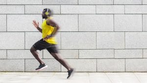 Fit black man running so fast his image starts to blur