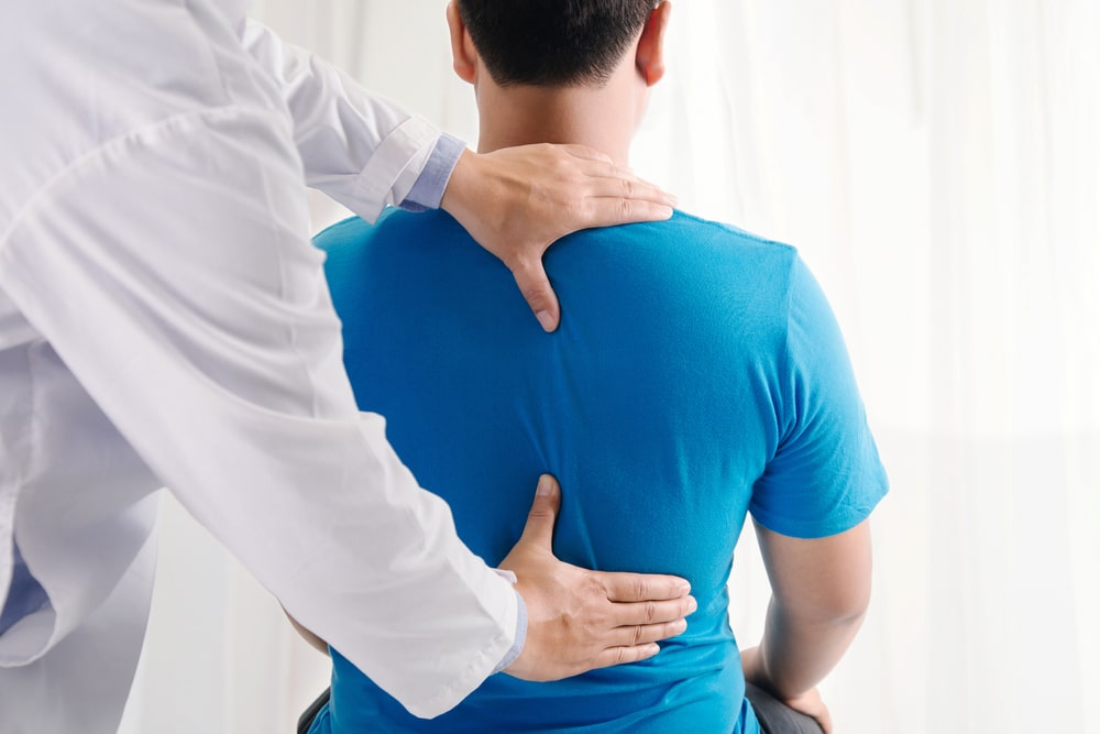 Photo of a Chiropractor Adjusting Spine