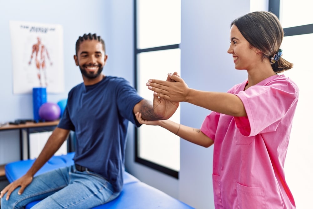 Chiropractor Stretching A Patients Hand