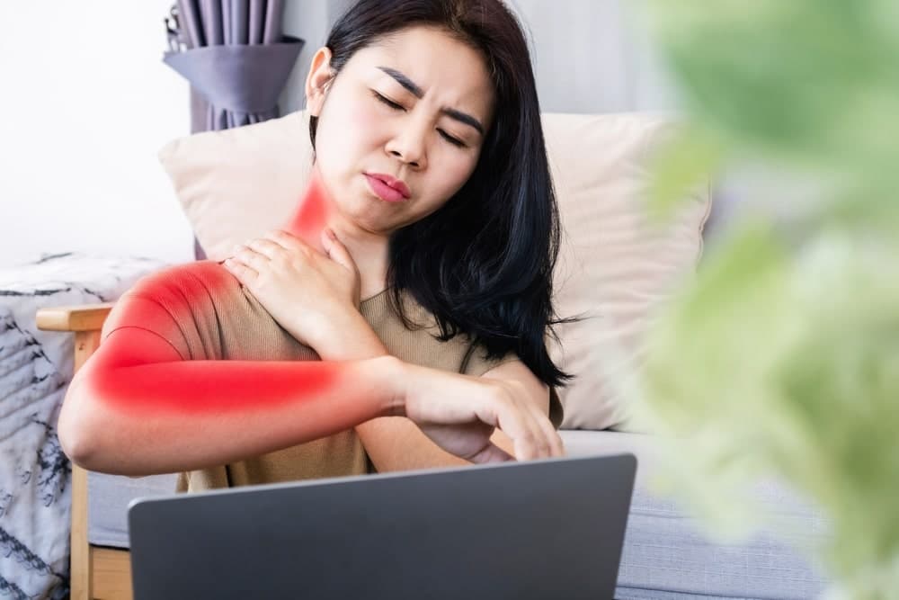 Woman Holding Her Neck In Pain