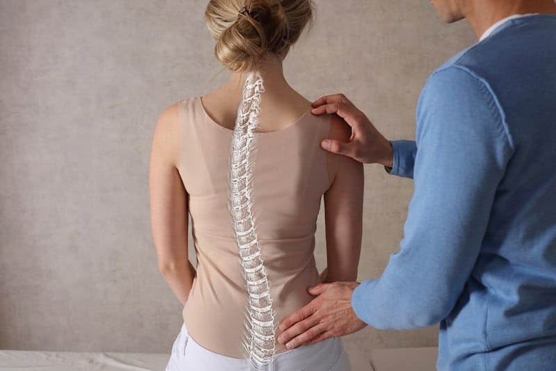 Doctor Looking At A Patient With Scoliosis
